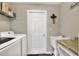 Functional laundry room features modern washer/dryer, sink, and storage shelves at 1034 Corso Dr, Winter Haven, FL 33884
