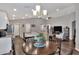 Kitchen, dining and living room open floor plan under vaulted ceilings and recessed lighting at 1034 Corso Dr, Winter Haven, FL 33884
