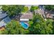 Aerial view showcasing a private screened-in pool, mature trees, and the backyard of the property at 111 Beverly Dr, Winter Haven, FL 33884