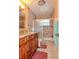 Updated bathroom with a tiled shower, dark wood vanity, and modern fixtures at 111 Beverly Dr, Winter Haven, FL 33884