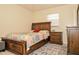 Cozy bedroom featuring a wooden bed frame, with an adjacent drawer and stylish rug at 111 Beverly Dr, Winter Haven, FL 33884