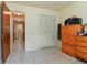This bedroom features neutral walls, a closet with louvered doors, and tile floors at 111 Beverly Dr, Winter Haven, FL 33884
