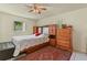 Comfortable bedroom featuring wood furniture, a red patterned rug, and a ceiling fan at 111 Beverly Dr, Winter Haven, FL 33884