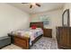 This bedroom features a queen bed, tile floors, a window with blinds, and a dresser at 111 Beverly Dr, Winter Haven, FL 33884