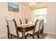 Formal dining room featuring an elegant chandelier, modern furniture, and natural light at 111 Beverly Dr, Winter Haven, FL 33884