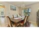 Bright dining room with chandelier, large window and view into living room at 111 Beverly Dr, Winter Haven, FL 33884