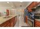 This updated kitchen features stainless steel appliances, granite countertops, and light tile flooring at 111 Beverly Dr, Winter Haven, FL 33884