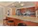 Kitchen with stainless steel appliances, granite countertops, wooden cabinets and bar stool seating at the island at 111 Beverly Dr, Winter Haven, FL 33884