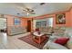 Inviting living room with a ceiling fan, a patterned rug, and comfortable leather seating at 111 Beverly Dr, Winter Haven, FL 33884