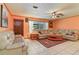 Cozy living room with ceiling fan, patterned rug and comfortable leather couches at 111 Beverly Dr, Winter Haven, FL 33884