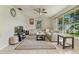 Bright living room featuring tile floors, large windows, ceiling fan, and a comfortable sectional sofa at 111 Beverly Dr, Winter Haven, FL 33884