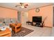 The living room has tile floors, a modern ceiling fan and a television with a display of flowers at 111 Beverly Dr, Winter Haven, FL 33884