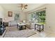 Bright living room featuring tile floors, large windows, ceiling fan, and a comfortable sectional sofa at 111 Beverly Dr, Winter Haven, FL 33884