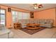 Spacious living room featuring tile floors, ceiling fan and large sectional sofa at 111 Beverly Dr, Winter Haven, FL 33884