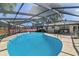 Large screened-in pool with an attached outdoor dining area and ample space for entertaining at 111 Beverly Dr, Winter Haven, FL 33884