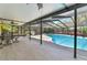 This covered patio features a pool view, tiled floors, ceiling fans, and a grill at 111 Beverly Dr, Winter Haven, FL 33884