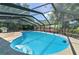 Large screened-in pool has in-pool steps and an attached outdoor dining area, perfect for entertaining at 111 Beverly Dr, Winter Haven, FL 33884