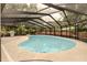Wide shot of the screened-in pool, with a concrete deck and BBQ grill at 111 Beverly Dr, Winter Haven, FL 33884