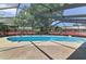 The property features a large screened-in pool with a spacious concrete pool deck and metal ladder at 111 Beverly Dr, Winter Haven, FL 33884