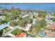 Aerial view of a cozy home nestled among mature trees near a shimmering lake at 1118 Cypress W Pt, Winter Haven, FL 33884