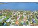 Aerial view of lakeside community showcases waterfront homes and lush landscaping near a big lake at 1118 Cypress W Pt, Winter Haven, FL 33884