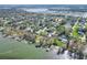 Aerial view of a neighborhood nestled along the shoreline of a lake at 1118 Cypress W Pt, Winter Haven, FL 33884