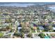 Aerial view of a residential neighborhood and a home nestled among mature trees at 1118 Cypress W Pt, Winter Haven, FL 33884