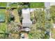 Aerial view of the property showcasing mature trees and a spacious driveway at 1118 Cypress W Pt, Winter Haven, FL 33884