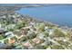 Aerial view of a residential neighborhood with a lake in the background at 1118 Cypress W Pt, Winter Haven, FL 33884