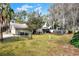 Well-maintained backyard with a swing set, mature trees, and a lush lawn at 1118 Cypress W Pt, Winter Haven, FL 33884