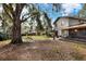 Expansive backyard featuring mature trees, a swing set, and ample space at 1118 Cypress W Pt, Winter Haven, FL 33884