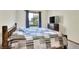 Bedroom with natural light, a bed with a gray comforter, and a flat screen TV at 1118 Cypress W Pt, Winter Haven, FL 33884