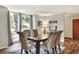 Formal dining room with hardwood floors, large window, and seating for six at 1118 Cypress W Pt, Winter Haven, FL 33884