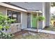Inviting entryway features a green door, stone accents, and a 'Welcome' sign, creating a warm ambiance at 1118 Cypress W Pt, Winter Haven, FL 33884