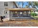 The home boasts a screened porch next to a brick patio with a backyard view at 1118 Cypress W Pt, Winter Haven, FL 33884