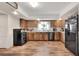 Charming kitchen features wood cabinets, tile countertops, and stainless steel appliances at 1118 Cypress W Pt, Winter Haven, FL 33884