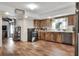 Open kitchen featuring wood cabinets, tile countertops, modern appliances, and backyard access at 1118 Cypress W Pt, Winter Haven, FL 33884