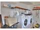 Functional laundry room with a utility sink and a washer and dryer at 1118 Cypress W Pt, Winter Haven, FL 33884