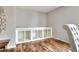 Bright room featuring built-in shelving, hardwood floors, and minimalist decor at 1118 Cypress W Pt, Winter Haven, FL 33884