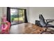 Hardwood floors, sliding glass doors to the back, desk, and gamer chair at 1118 Cypress W Pt, Winter Haven, FL 33884