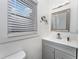 Bright bathroom featuring a modern vanity, sleek mirror, and a sunlit window at 1125 Josephine St, Lakeland, FL 33815