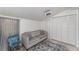 Bright bedroom featuring a gray sofa, natural light, and closet space at 1125 Josephine St, Lakeland, FL 33815