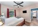 Inviting bedroom with a ceiling fan, window views, and convenient access to the ensuite at 1125 Josephine St, Lakeland, FL 33815