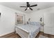 Bright bedroom features a ceiling fan, wood floors, and a comfortable bed with floral bedding at 1125 Josephine St, Lakeland, FL 33815