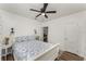 Inviting bedroom showcases a plush bed with floral bedding, ceiling fan, and warm wood flooring at 1125 Josephine St, Lakeland, FL 33815