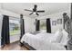 Bright bedroom featuring a four-poster bed and natural light from two windows at 1125 Josephine St, Lakeland, FL 33815