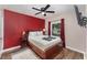 Cozy bedroom featuring a plush bed, a ceiling fan, and bright, colorful accents at 1125 Josephine St, Lakeland, FL 33815