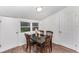 Cozy dining area with a wood table, decorative chairs, and natural light from a window at 1125 Josephine St, Lakeland, FL 33815