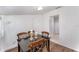 Bright dining area featuring wood-look floors, a dark wood table, and charming decor at 1125 Josephine St, Lakeland, FL 33815