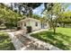 Charming home with blue door, lush landscaping, and driveway at 1125 Josephine St, Lakeland, FL 33815